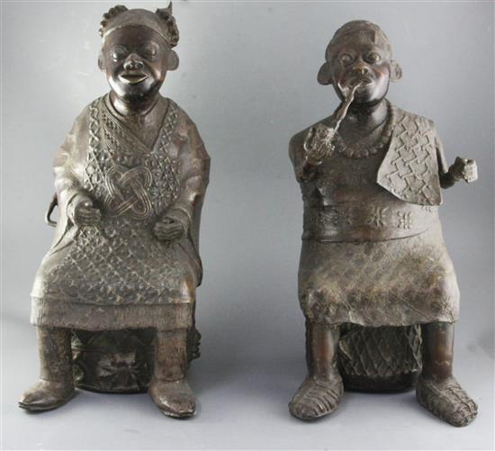A pair of large Bamum People of Cameroon bronze figures of a seated King Mbuembe and the Queen, 56cm and 53cm